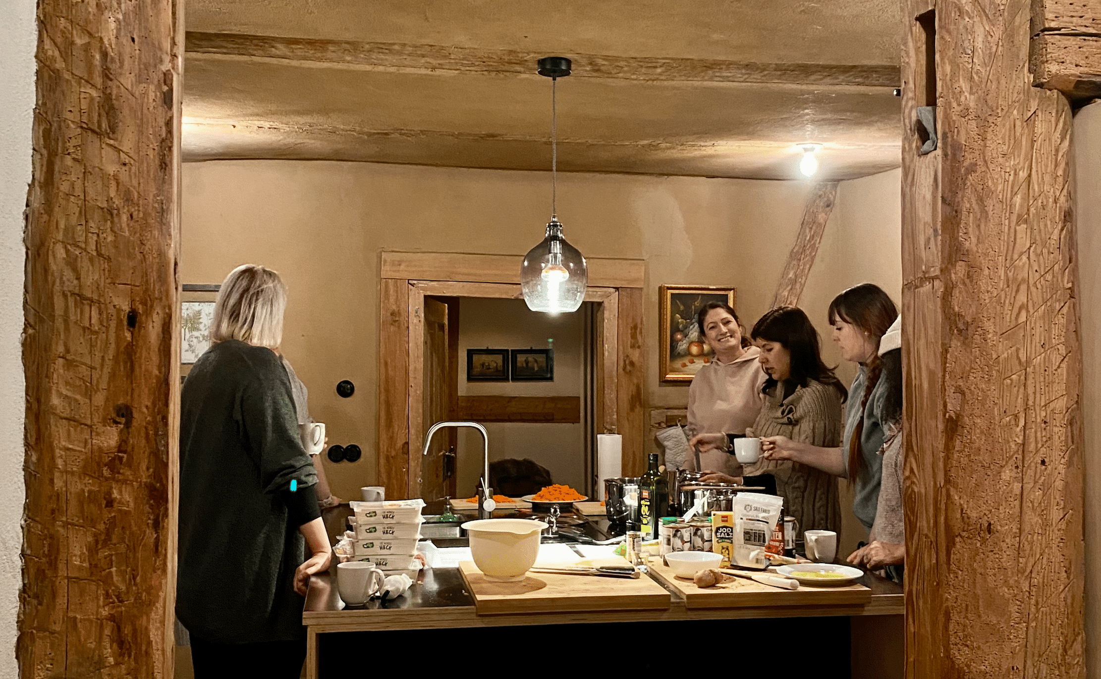 Look into the kitchen, Mashies chatting and laughing at the team retreat